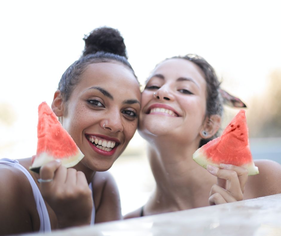 Models with hydrated skin holding watermelons show the benefits of watermelon for your skin.