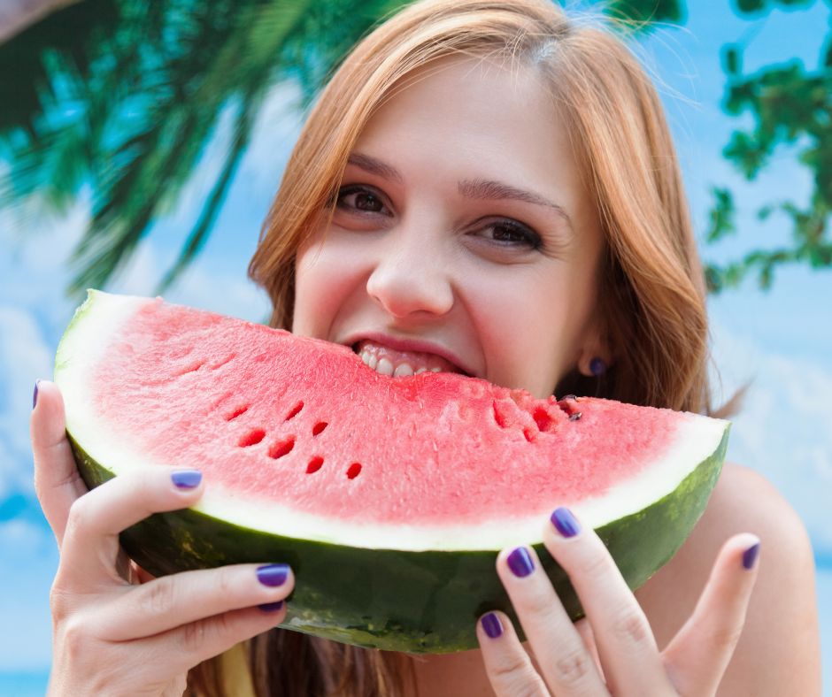 Model eating watermelon to boost collagen production and gain the benefits of watermelon for your skin.
