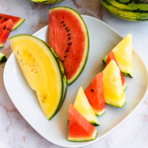 Yellow Watermelon sliced and displayed alongside the traditional red watermelons.